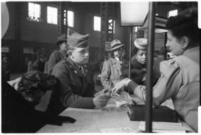 Clerk assisting military serviceman at information booth, Union Station, Chicago, May 1948