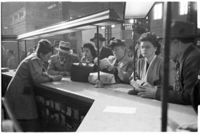 Clerk assists travelers at information booth, Union Station, Chicago, May 1948