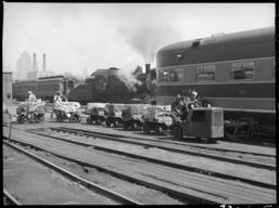 Workers delivering supplies to passenger train, 14th Street passenger yards, Chicago, May 1948