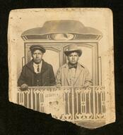 Men posed with portrait gallery railroad background, Oklahoma?, circa 1910s