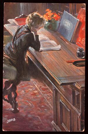 Boy reading book on desk