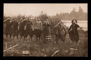 Line of eight women eating watermelon